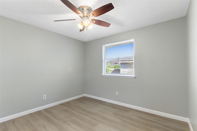 spare room with ceiling fan, light hardwood / wood-style floors, and a textured ceiling