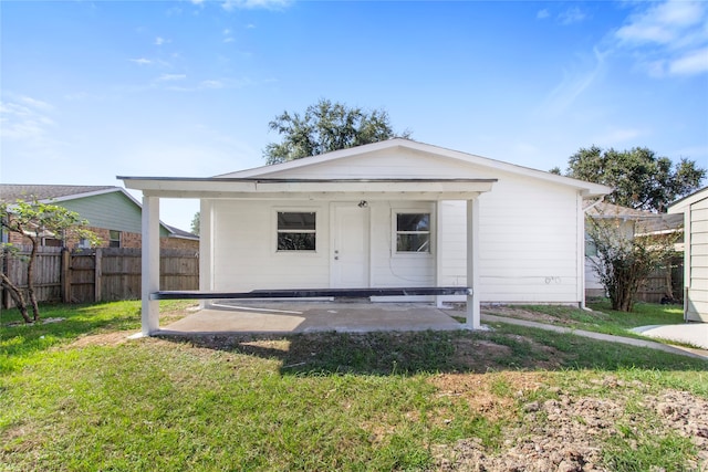 view of front of property with a patio and a front lawn