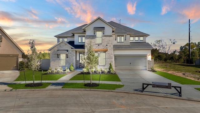 view of front facade featuring a garage and a lawn