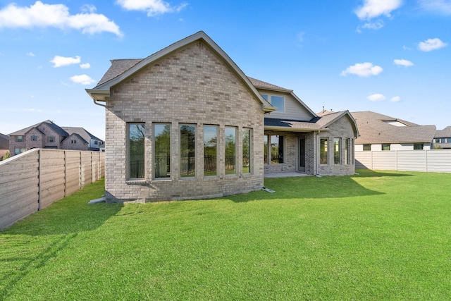 back of house with a lawn