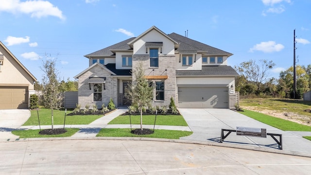 view of front of home with a front yard and a garage