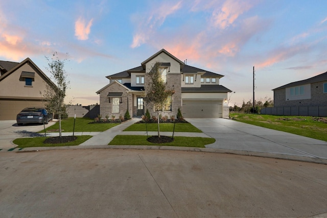 view of front of property featuring a garage and a yard