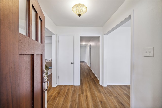 corridor with light wood-type flooring