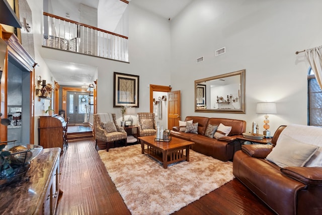 living room featuring visible vents and wood finished floors