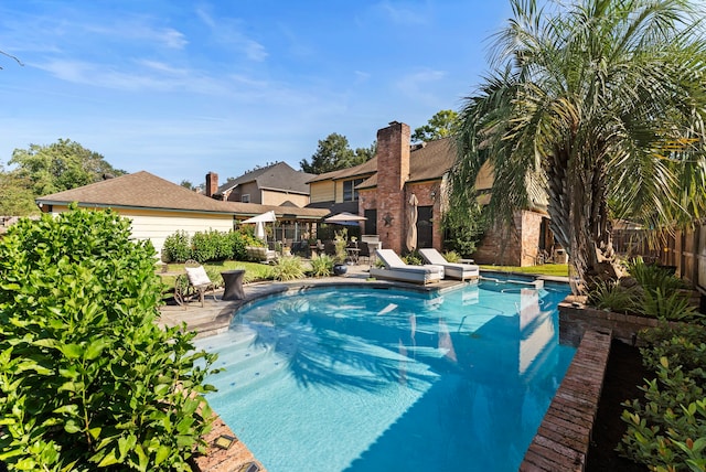 view of swimming pool featuring a patio, fence, and a fenced in pool