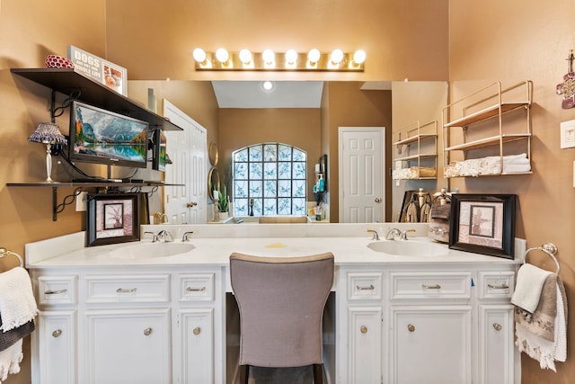 bathroom featuring a sink and double vanity