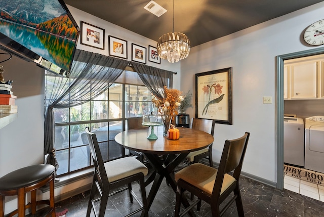 dining space with baseboards, visible vents, washer and clothes dryer, an inviting chandelier, and marble finish floor