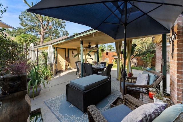 view of patio with a ceiling fan, outdoor dining space, a fenced backyard, and an outdoor hangout area