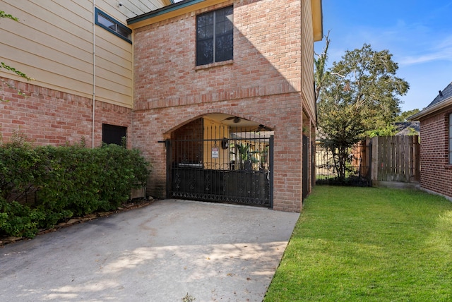 view of gate featuring a yard and fence