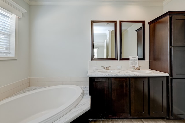 bathroom with crown molding, tiled tub, and vanity