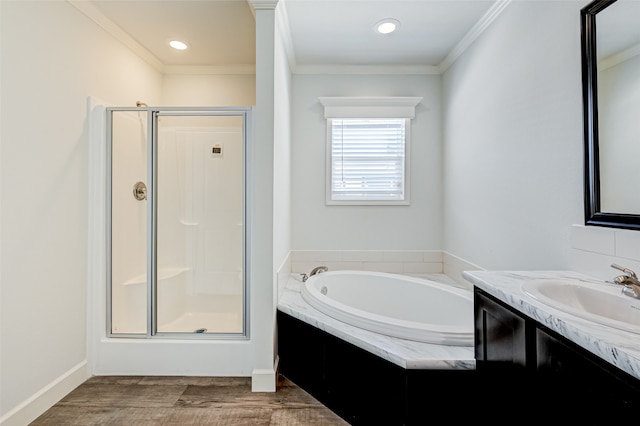 bathroom featuring independent shower and bath, vanity, wood-type flooring, and ornamental molding