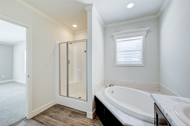 bathroom with shower with separate bathtub, vanity, ornamental molding, and hardwood / wood-style flooring