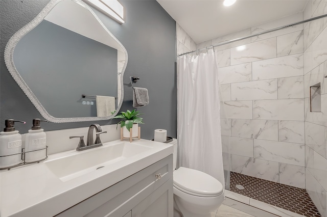 bathroom featuring walk in shower, vanity, and toilet