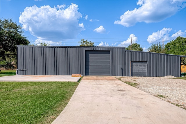 view of outdoor structure featuring a lawn and a garage