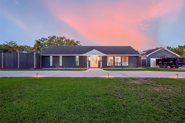 ranch-style home featuring a lawn