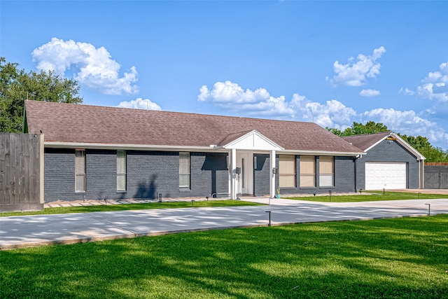 ranch-style house with a garage and a front lawn