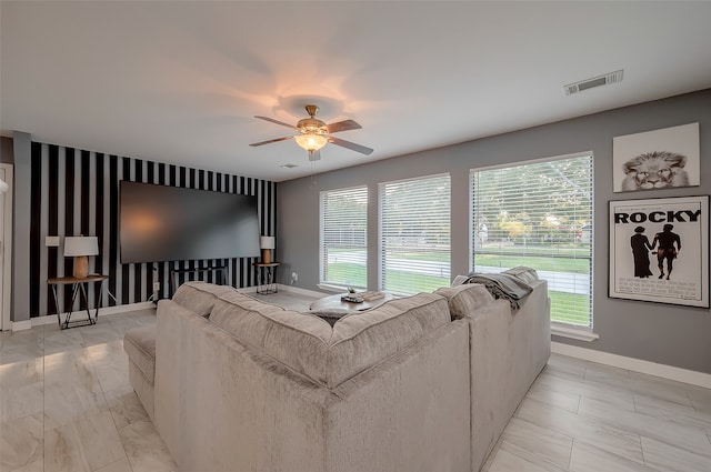 living room with ceiling fan and plenty of natural light