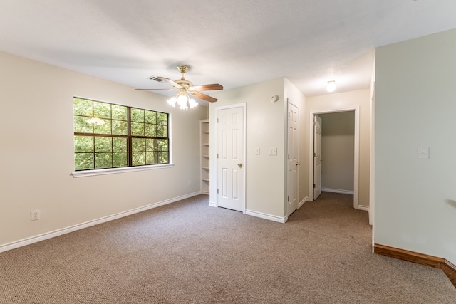 unfurnished bedroom with ceiling fan and carpet