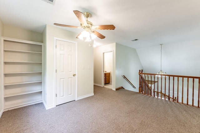 interior space featuring light carpet, vaulted ceiling, and ceiling fan