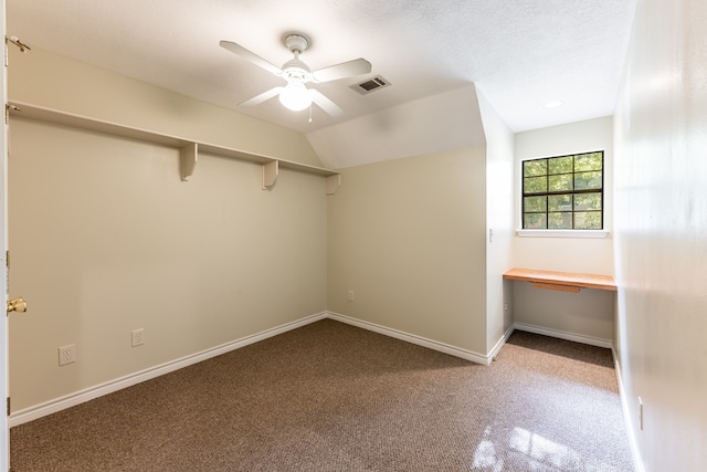 carpeted empty room with ceiling fan and vaulted ceiling