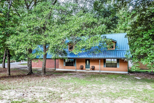 rear view of house with a yard