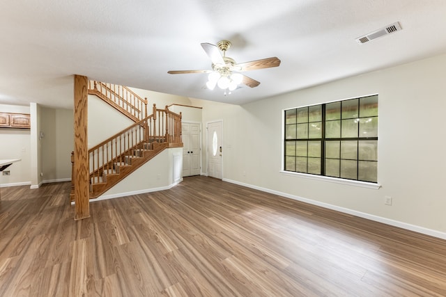 unfurnished living room featuring a textured ceiling, hardwood / wood-style floors, and ceiling fan