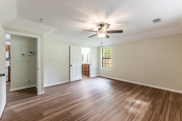 unfurnished bedroom with wood-type flooring, ensuite bath, and ceiling fan