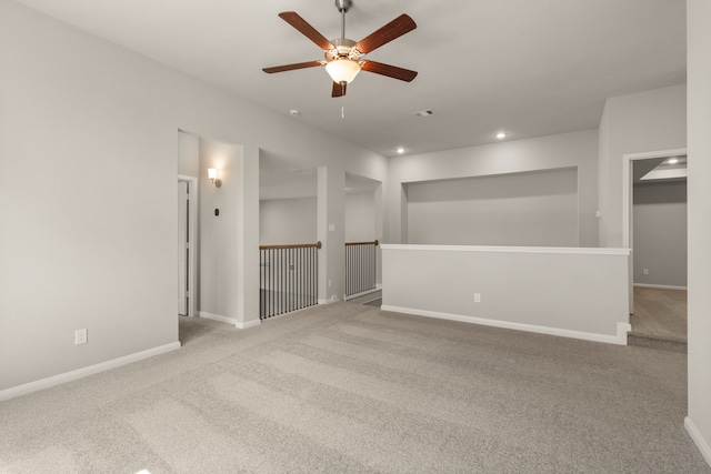 unfurnished room featuring ceiling fan and light carpet