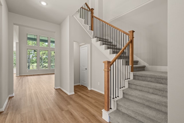 stairway with hardwood / wood-style flooring