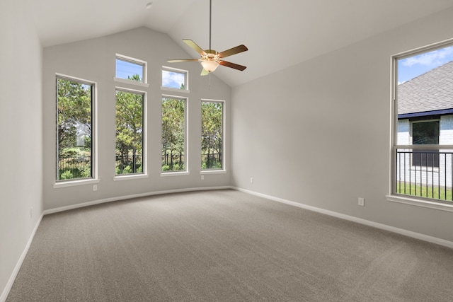 carpeted spare room featuring ceiling fan and lofted ceiling