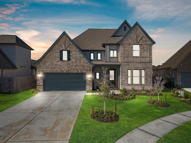 view of front of house featuring a garage, brick siding, fence, concrete driveway, and a front lawn