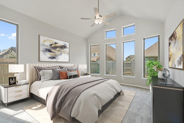 carpeted bedroom with high vaulted ceiling, ceiling fan, and baseboards