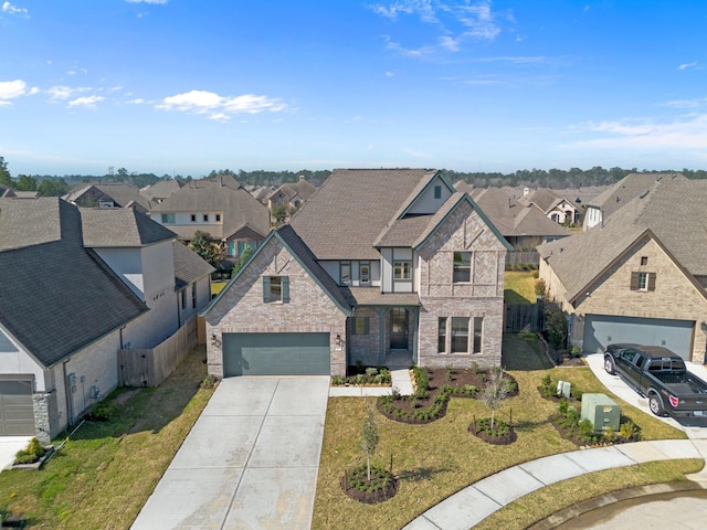 view of front of house featuring driveway, a residential view, and a front yard