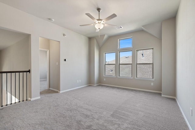 empty room featuring light colored carpet, visible vents, ceiling fan, and baseboards