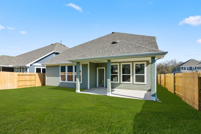 back of house with a lawn and a patio area