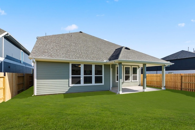 back of house featuring a lawn and a patio