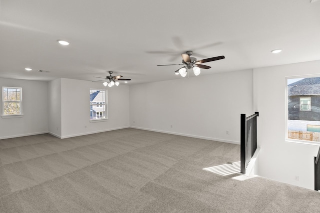 unfurnished room featuring light carpet and ceiling fan