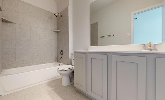 full bathroom featuring vanity, tiled shower / bath combo, toilet, and tile patterned flooring