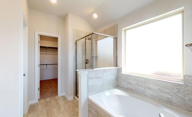 bathroom featuring plus walk in shower and vaulted ceiling