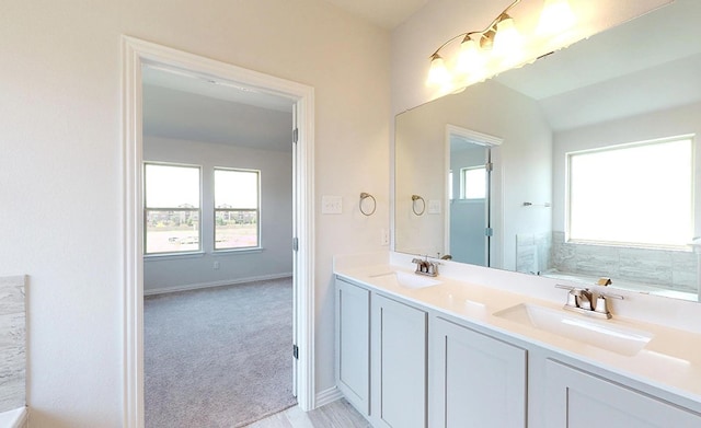 bathroom with a bathing tub and vanity