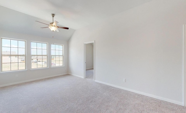 spare room featuring light colored carpet, ceiling fan, and lofted ceiling