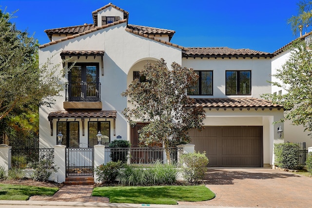 mediterranean / spanish home featuring a garage