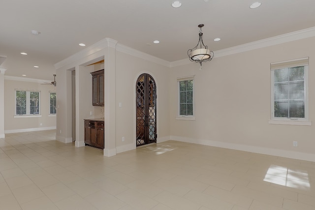 unfurnished living room featuring light tile patterned floors, ornamental molding, and ceiling fan