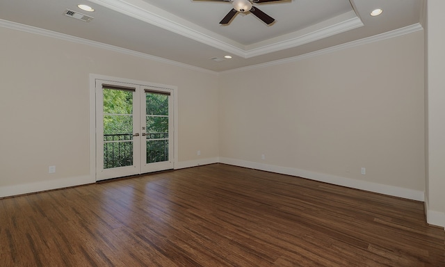 unfurnished room featuring ceiling fan, ornamental molding, french doors, a tray ceiling, and dark hardwood / wood-style floors