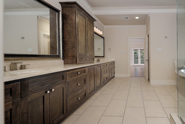 bathroom with tile patterned floors, vanity, and crown molding