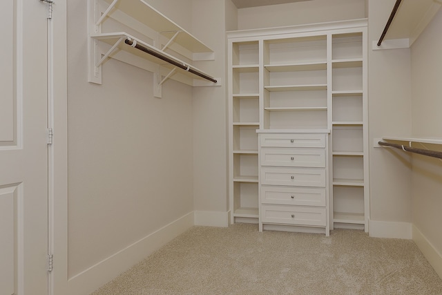 walk in closet with carpet