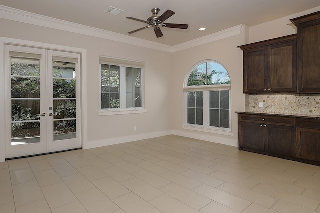 interior space featuring crown molding, light tile patterned flooring, ceiling fan, and french doors