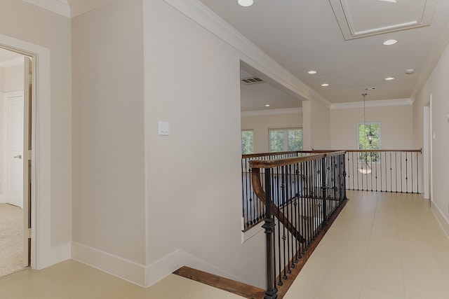 hall featuring crown molding and a chandelier