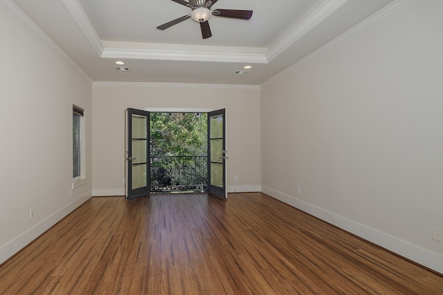 spare room with crown molding, hardwood / wood-style floors, ceiling fan, and a raised ceiling