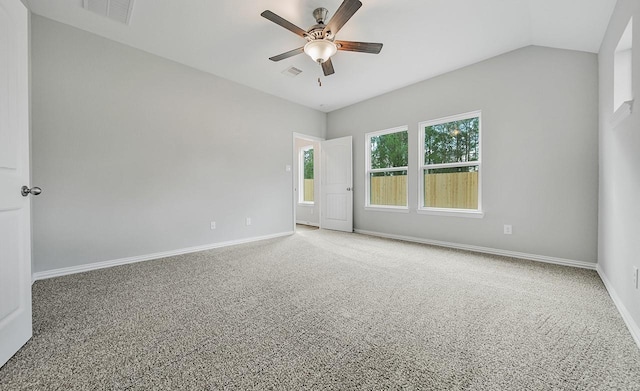 spare room with ceiling fan, carpet floors, and vaulted ceiling